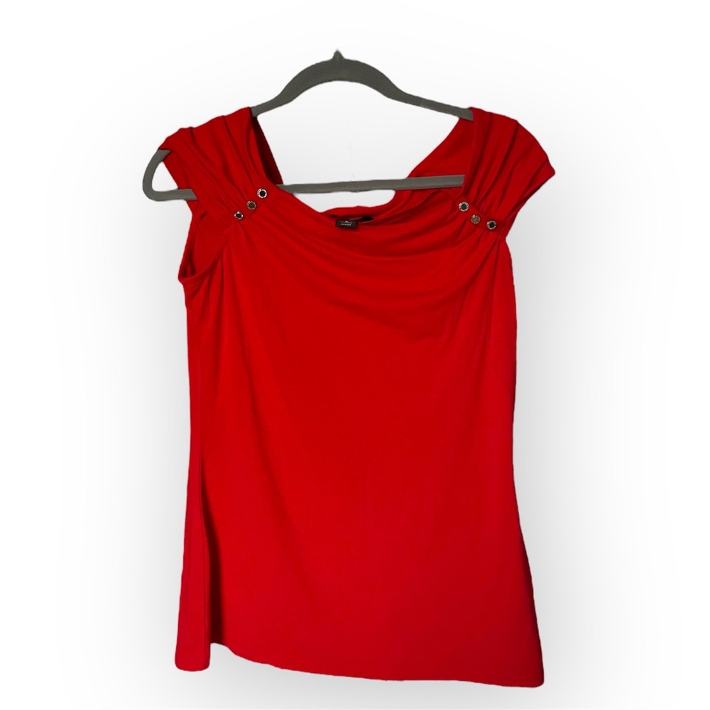 Red sleeveless blouse with button 
straps and a draped neckline